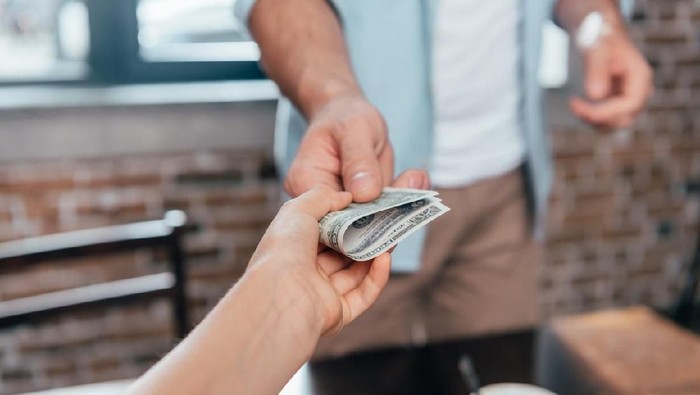 cropped shot of dad giving pocket money to daughter