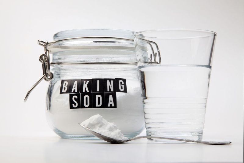 Spoonful of baking soda and glass of water