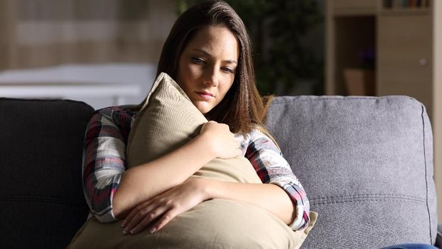 Thoughtful woman at home - copyspace