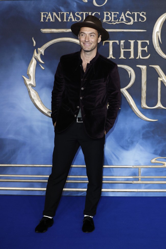 Jude Law menebar pesonanya dalam balutan jaket velvet dan topi. Tak diragukan ia pun mencuri perhatian di karpet merah. Foto: Getty Images