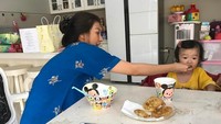 Kecil-kecil sudah makan gorengan nih. Thalia sedang disuapi makan apa ya? Di depannya terlihat piring berisi bakwan. Foto: instagram @thaliaputrionsu