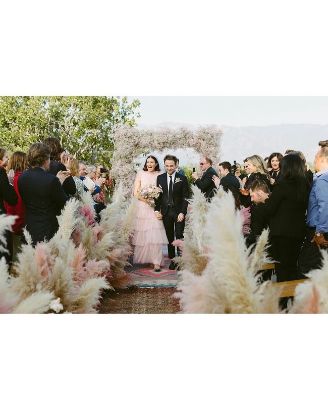 Karpet menuju altar tampak dipagari dengan tanaman ilalang berwarna off-white dan pink. Unik! (Foto: Instagram/@mandymooremm)
