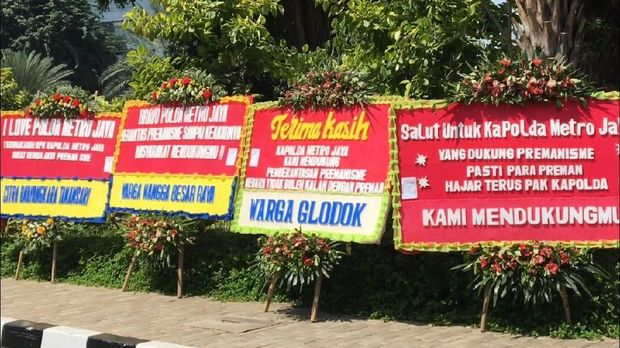 Puluhan karangan bunga itu tampak memenuhi halaman depan gedung.
