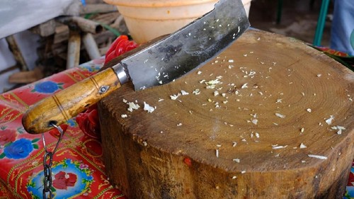 Butchers set for chopping meat: wooden block and chopper with rough handle
