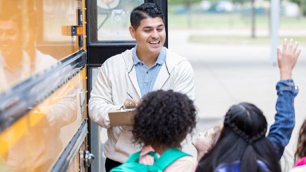 Beautiful children school children with flowers for the teachers at school on a holiday