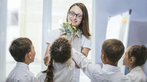 Beautiful children school children with flowers for the teachers at school on a holiday