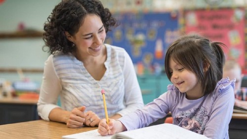 Beautiful children school children with flowers for the teachers at school on a holiday