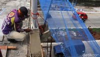 Pekerja tengah membuat pembatas JPO.