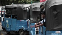 Seorang sopir mengantre dari dalam bajajnya. Seorang sopir mengantre dari dalam bajajnya.
