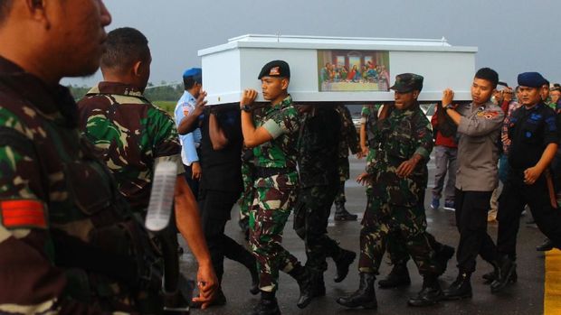 Prajurit TNI dan Polri mengusung peti jenazah korban KKB di Bandara Moses Kilangin Timika, Mimika, Papua, Jumat (7/12).