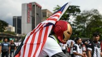 Massa aksi memakai berbagai pernak-pernik saat aksi, salah satunya memakai topeng Iron Man (Foto: AFP)