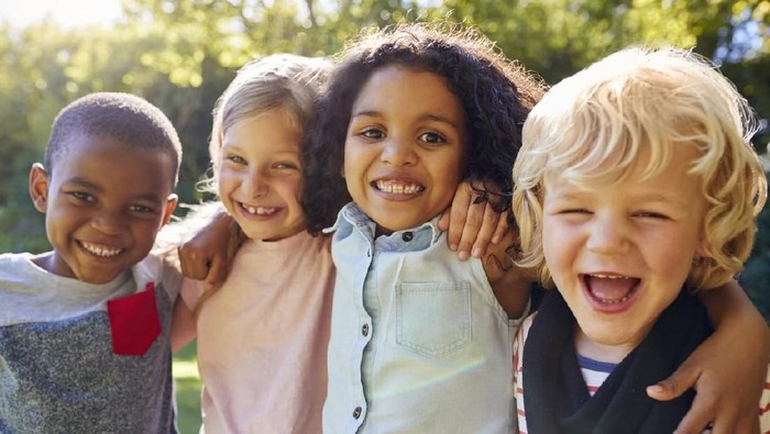 Four kids hanging out together in the garden