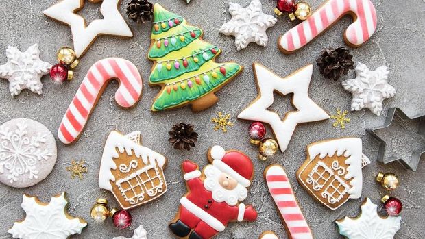 On a plate christstollen (Stollen) and christmas Ornaments. - Stolle made of loaf-shaped cake, dried fruit, and covered with powdered sugar. Traditional German cake. Useful christmas background for greeting card.