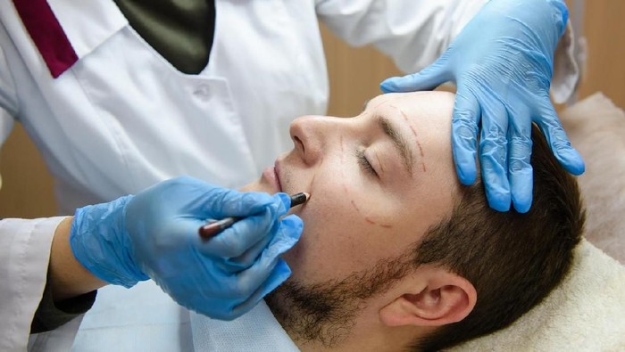 Filler forehead injection for male face in beauty clinic