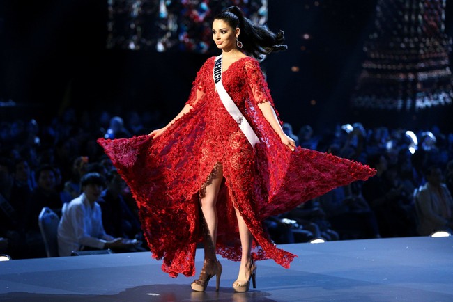 Dibalut gaun merah cerah, Miss Mexico Andrea Toscano membuat penampilan yang mencuri perhatian dengan gaun brokat berhias payet. Foto: REUTERS/Athit Perawongmetha