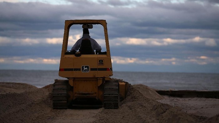 LONG BEACH ISLAND, NJ - OCTOBER 31: A Bulldozer pushes sand back on the beach, on October 31, 2012 in Long Beach Island, New Jersey. Earlier in the week Hurricane Sandy made landfall on New Jersey coastline bringing damaging winds and record floodwaters.  (Photo by Mark Wilson/Getty Images)