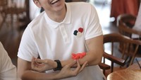 Sambil menikmati kopi dan makanan, Harvey tertawa lepas dengan benda imut di tangannya. Kira-kira benda apa ya? Foto: Instagram @sandradewi88