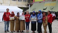 Dumasi M M Samosir, Direktur Asuransi Sinar Mas, bersama Mariko Abu Bakar, Kepala Sekolah SD Inpres 1 Lolu, Palu,dan Guru-guru berfoto bersama usai acara literasi dan inklusi keuangan di depan tenda darurat lokasi pengungsian Balaroa, Palu, Sulteng. Foto: dok. Asuransi Sinar Mas