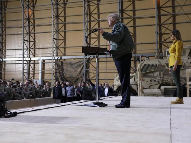 Sebelumnya, gayanya saat berada di Irak pun tak lepas dari kritikan netizen. Penyebabnya adalah sepatu boots Timberland yang menjadi andalan Melania. Sepatu tersebut menemani busana ibu satu anak itu yang terdiri dari jaket kuning mustard Victoria Beckham dan jeans hijau dari J Brand. (Foto: Reuters)