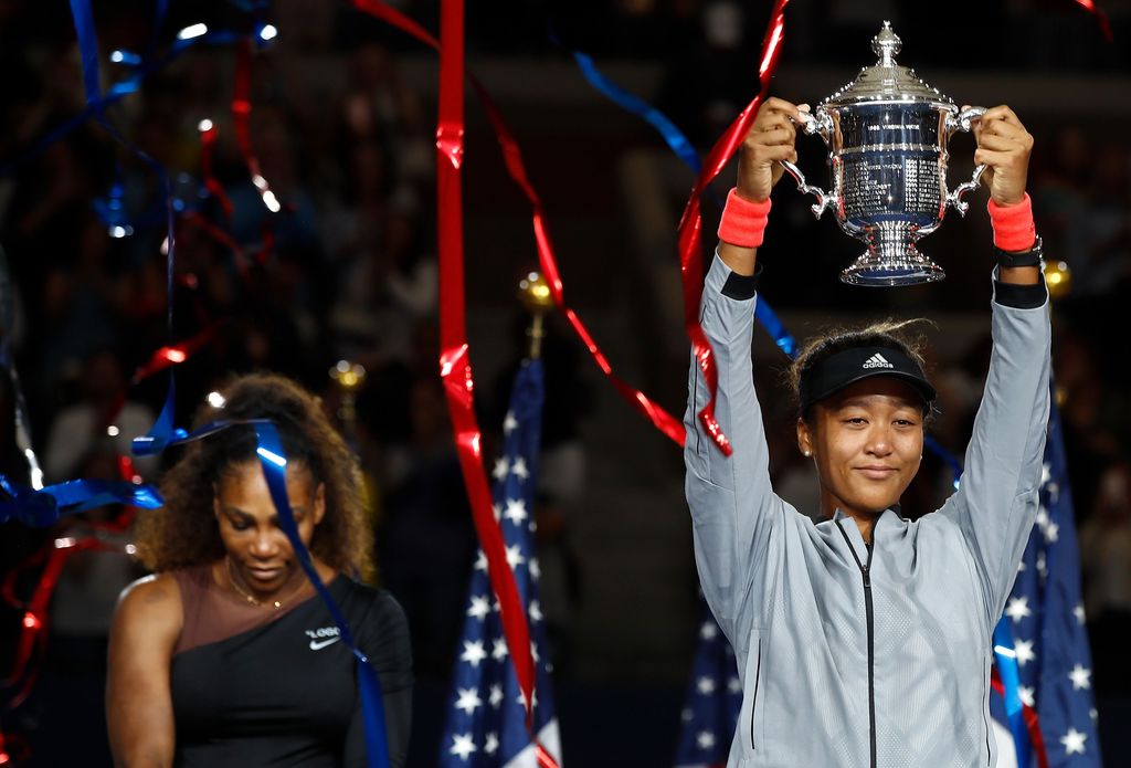 Naomi Osaka NEW YORK, NY - SEPTEMBER 08: Naomi Osaka of Japan poses with the championship trophy after winning the Women's Singles finals match against Serena Williams of the United States on Day Thirteen of the 2018 US Open at the USTA Billie Jean King National Tennis Center on September 8, 2018 in the Flushing neighborhood of the Queens borough of New York City. (Photo by Julian Finney/Getty Images)