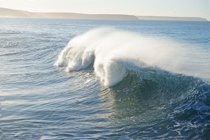 Breaking waves and sea spray in winter at Porthleven, Cornwall, England, UK