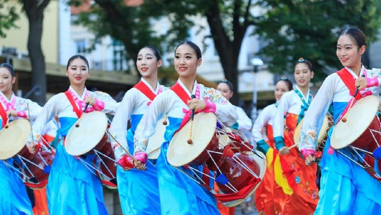 Ilustrasi Tarian Korea Veliko Tarnovo, Bulgaria- July 25, 2015: South Korean group for traditional music make performance in Veliko Tarnovo. South Korean group in traditional costumes plays traditional drum music on