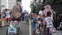 Anak-anak itu berkeliling sambil membawa wadah sebagai tempat untuk menampung uang saweran.
