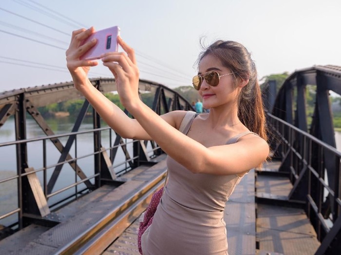 Portrait of young beautiful Asian tourist woman relaxing at Kanchanaburi province in Thailand