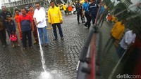 Anies sempat ikut membersihkan lapangan dengan menyemprotkan air.