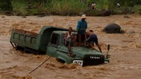 Truk pengangkut batu yang berada di tengah sungai Batang Kuranji akibat terseret banjir di Kecamatan Pauh, Padang, Sumatera Barat, Rabu (2/1/2019). ANTARA FOTO/Muhammad Arif Pribadi.