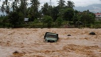 Air bah yang datang dengan tiba-tiba itu menyeret truk ke tengah sungai dan supir truk berhasil selamat. ANTARA FOTO/Muhammad Arif Pribadi.