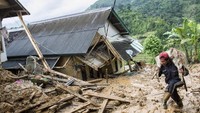 Seorang warga menyalamatkan barang berharga dan hewan ternak usai terjadinya longsor di kampung adat Sinarresmi, Cisolok, Sukabumi, Jawa Barat.