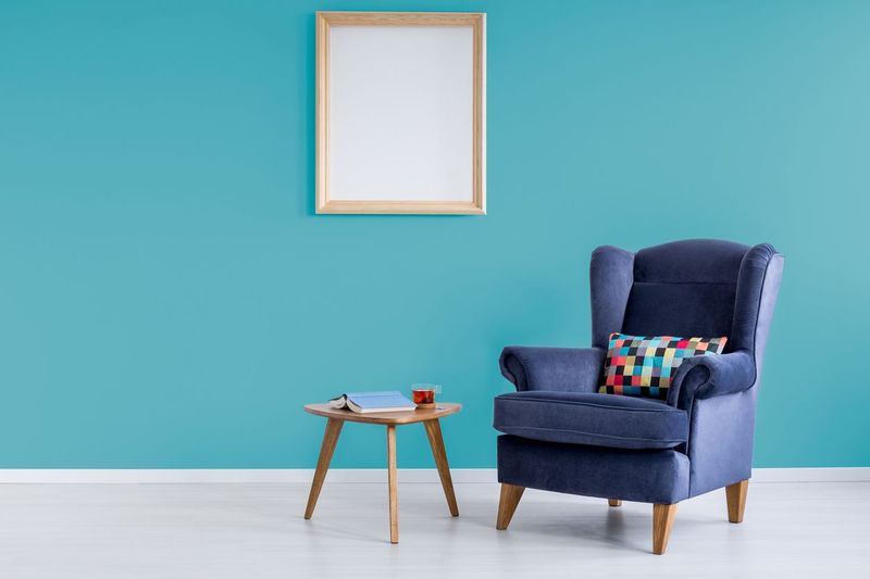 White living room with round chair, rattan sofa and table