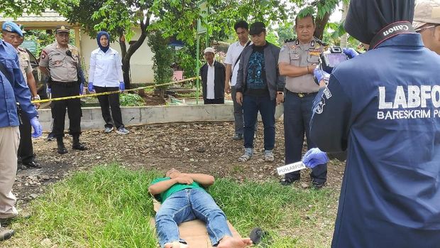 Seorang pria berbaring di atas rumput memerankan almarhum.
