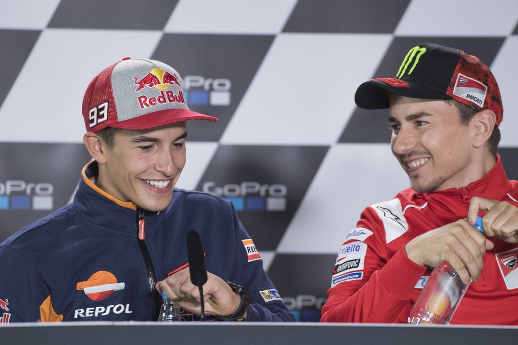 NORTHAMPTON, ENGLAND - AUGUST 23:  Jorge Lorenzo of Spain and Ducati Team and Marc Marquez of Spain and Repsol Honda Team (L) smile during the press conference pre-event during the MotoGp Of Great Britain - Previews at Silverstone Circuit on August 23, 2018 in Northampton, England.  (Photo by Mirco Lazzari gp/Getty Images)
