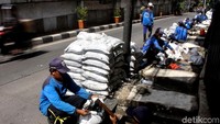 Petugas Sudin SDA saat mengangkut ratusan karung lumpur di Jalan KS Tubun, Jakarta Barat, Kamis (3/1/2019).