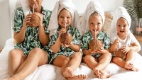 Mengenakan piyama bergambar daun, Eleesha dan ketiga anaknya asyik menyeruput kelapa muda. Mereka juga kompak mengenakan handuk di atas kepalanya. Foto: instagram @the.quinn.girls