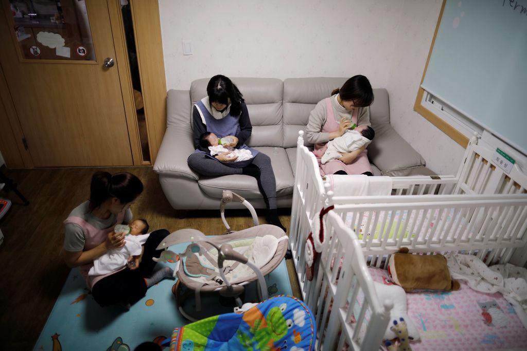Kim Mi-sung checks her daughter's homework before leaving for school, at their home in Seoul, South Korea, December 19, 2018. Picture taken December 19, 2018.   REUTERS/Kim Hong-Ji