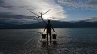 Seniman asal Jepang Daisuke Takeya melakukan pertunjukan bertajuk Yellow Memories di Pantai Talise, Teluk Palu, Sulawesi Tengah, Senin (7/1/2019). ANTARA FOTO/Basri Marzuki.