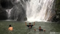Pengunjung bisa memilih, berenang sambil merasakan derasnya air terjun yang jatuh membasahi tubuh. Ataupun sebaliknya, berenang di bawah air terjun yang mengalir sedang (Abdy Febriady/detikTravel) 