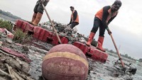 Sejumlah sampah yang menggenang di Waduk Cincin dibersihkan oleh petugas.