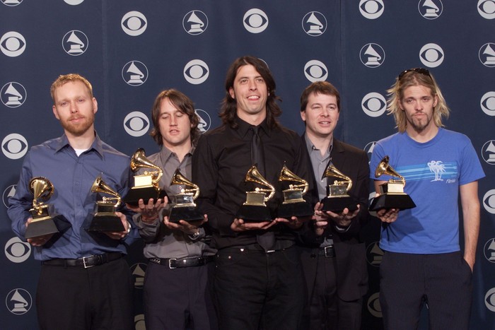 Dave Grohl, center, and the Foo Fighters pose backstage with Grammys they received for Best Rock Album and Best Music Video/Short Form at the 43rd Annual Grammy Awards at Staples Center in Los Angeles Wednesday, Feb. 21, 2001. Photo by Scott Gries/ImageDirect