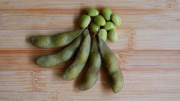 Young soy beans. Known as edamame with wood background.