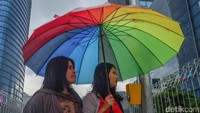 Beberapa warga menggunakan payung untuk menembus hujan. Cuaca ekstrim yang terjadi akhir-akhir ini membuat warga yang tak siap dengan payung, pasti akan kebasahan.
