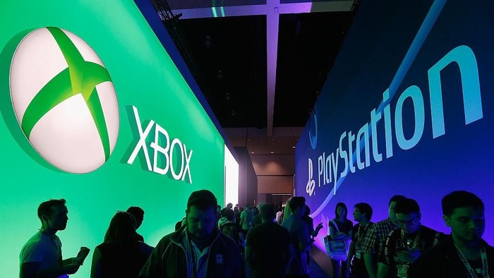 LOS ANGELES, CA - JUNE 16:  Game enthusiasts and industry personnel walk between the Microsoft XBox and the Sony PlayStation exhibits at the Annual Gaming Industry Conference E3 at  the Los Angeles Convention Center on June 16, 2015 in Los Angeles, California. The Los Angeles Convention Center will be hosting the annual Electronic Entertainment Expo (E3) which focuses on gaming systems and interactive entertainment, featuring introductions to new products and technologies.  (Photo by Christian Petersen/Getty Images)
