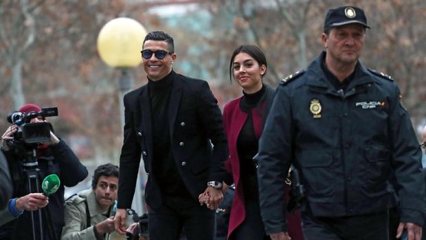 Portugal's soccer player Cristiano Ronaldo arrives with his girlfriend Georgina Rodriguez to appear in court on a trial for tax fraud in Madrid, Spain, January 22, 2019. REUTERS/Susana Vera