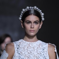 Tidak ketinggalan, sebuah mahkota yang dihiasi jajaran bola-bola mutiara turut menyempurnakan gaya model 17 tahun ini. Bak ratu, Kaia sukses menebar pesonanya di catwalk. Adalah Clare Waight Keller, direktur kreatif Givenchy yang merancang koleksi tersebut. Clare sempat menjadi sorotan saat terungkap bahwa dirinya yang mendesain gaun pengantin Meghan Markle tahun lalu. (Foto: Getty Images)