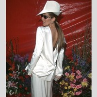 Celine Dion bereksperimen dengan gayanya di Oscars 1999. Dia tampil dengan blazer yang dipakai terbalik, senada dengan topi dan juga celana flare, tak lupa kacamata hitam yang membuat ia mencuri atensi. Foto: Istimewa