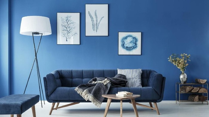 Simple bedroom with double bed, blue bedding, posters and window