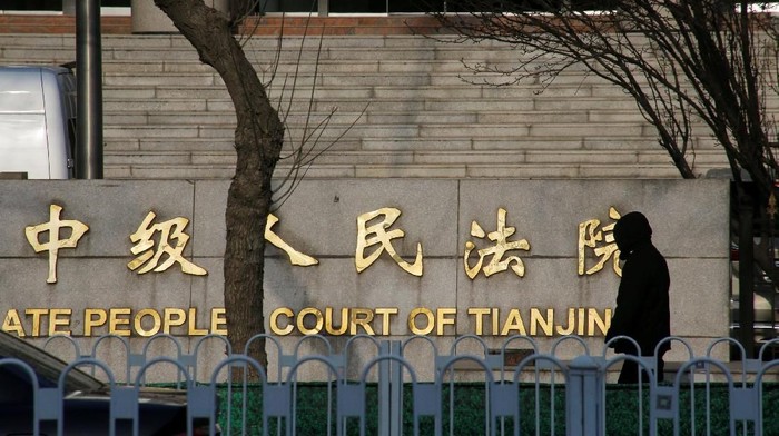 FILE PHOTO: A man walks outside an Intermediate Peoples Court where prominent rights lawyer Wang Quanzhang is being tried, in Tianjin, China December 26, 2018.  REUTERS/Thomas Peter/File Photo